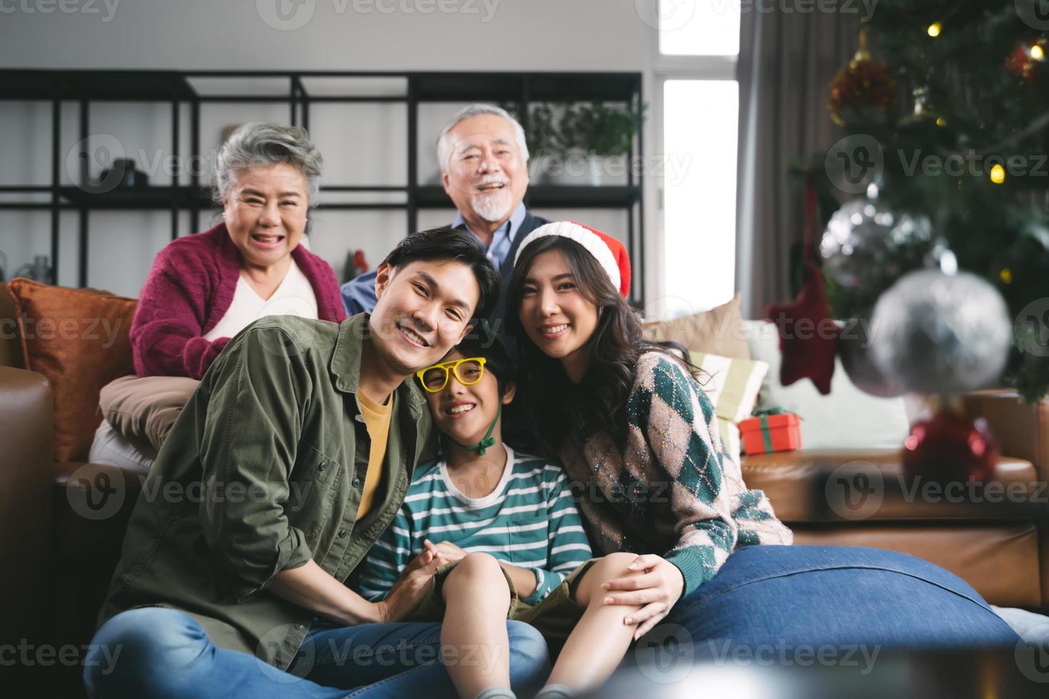Portrait Asian family near Christmas tree together at home. family, generation, christmas and people concept photo