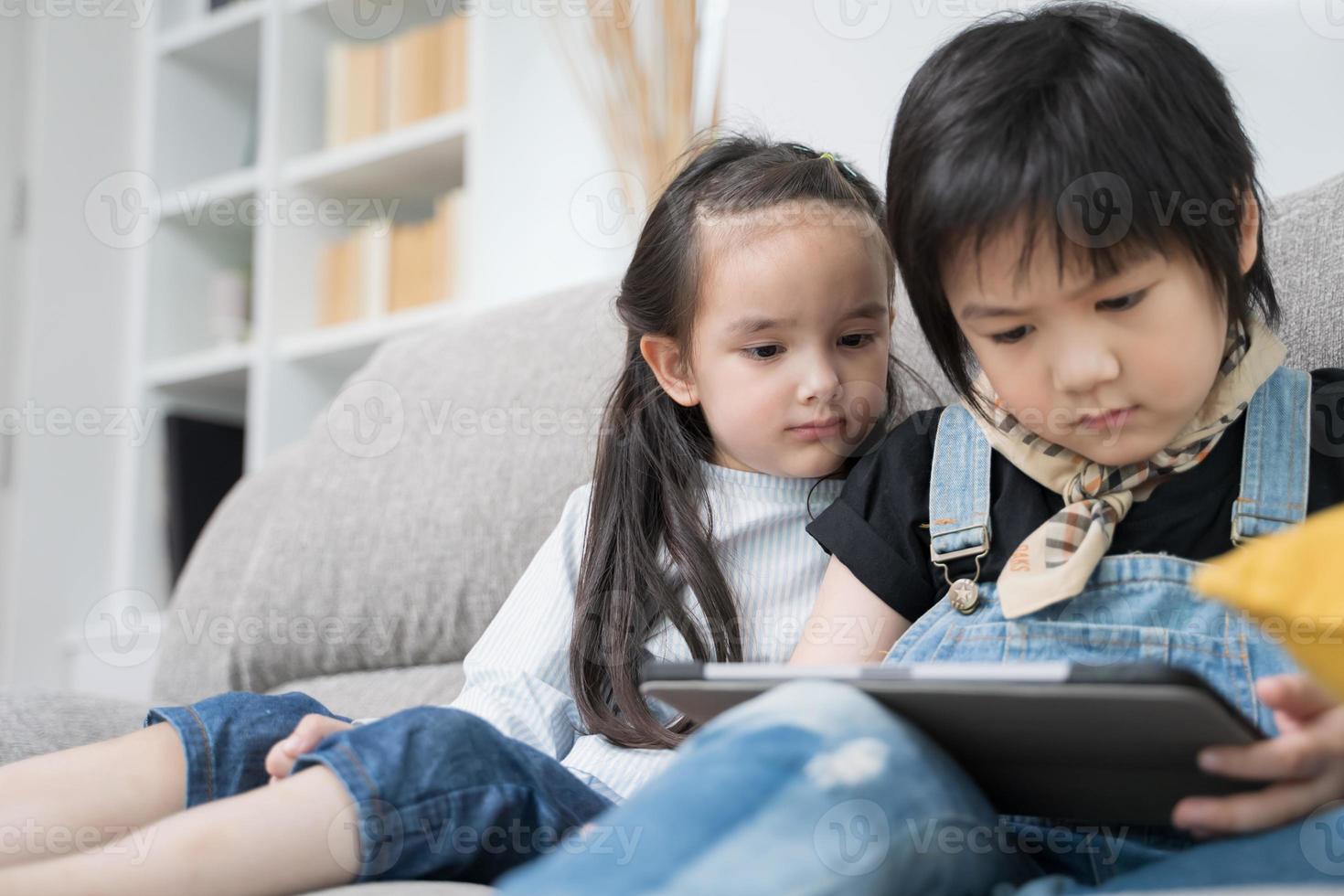 Children playing on tablet. photo