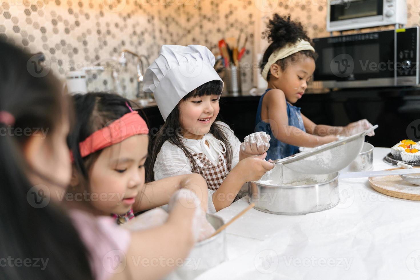 Group of kids are learning to cooking cookie photo