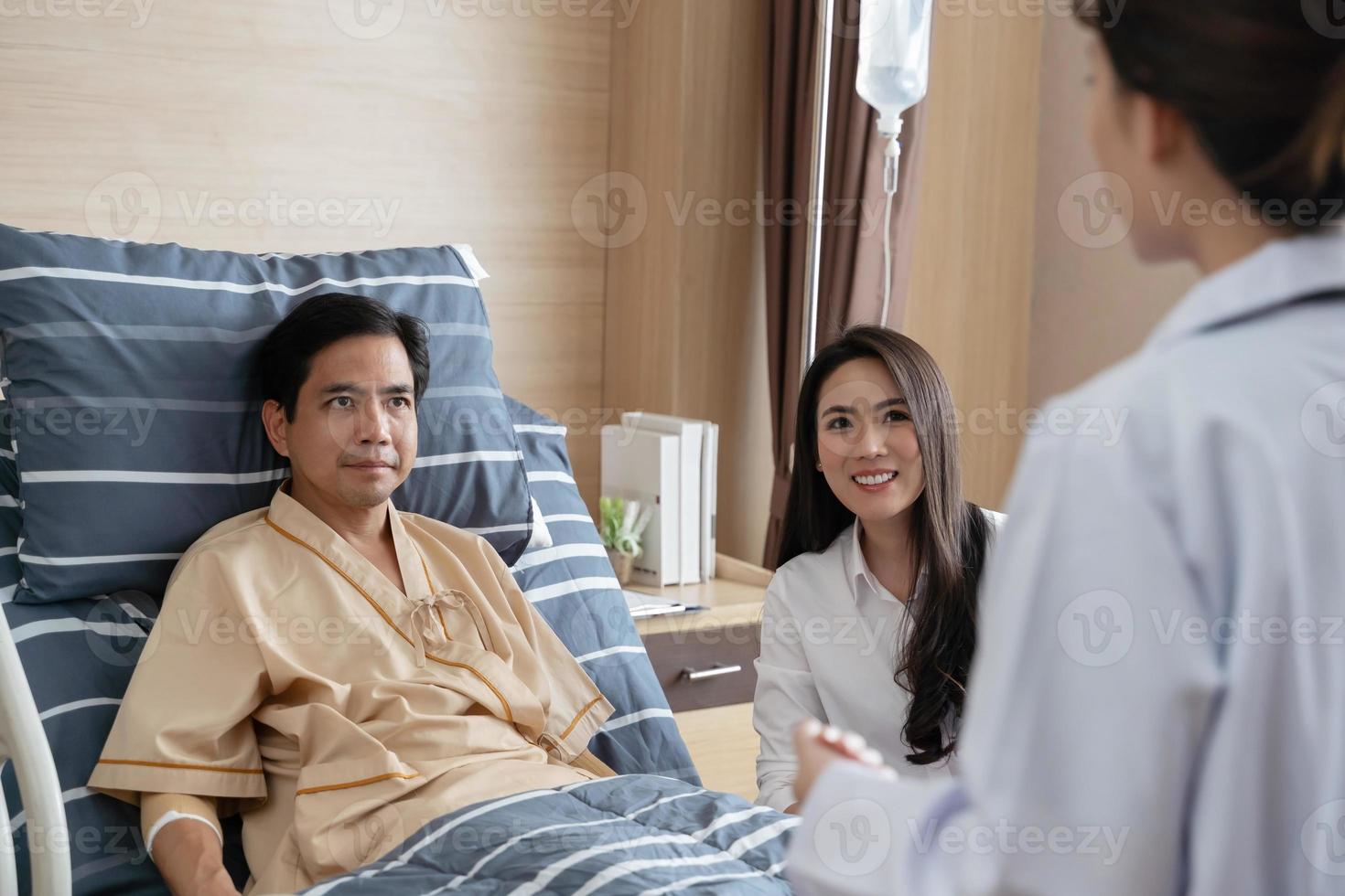 Doctors visit patients on hospital beds. photo