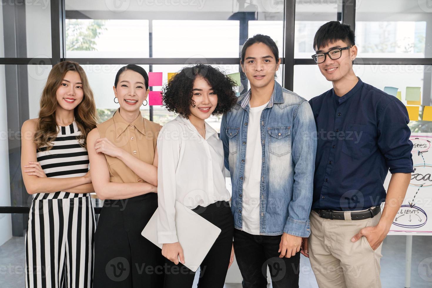 Portrait of Asian creative business team. Hipster Creative Startup Young business people in modern office. photo