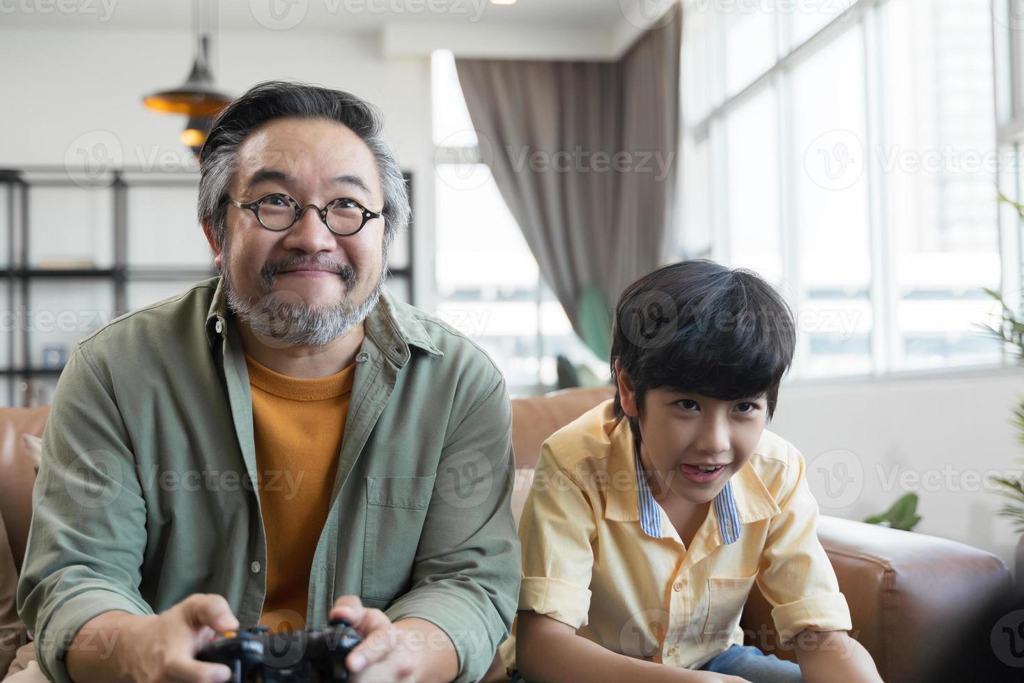 Son and dad playing video game at home photo