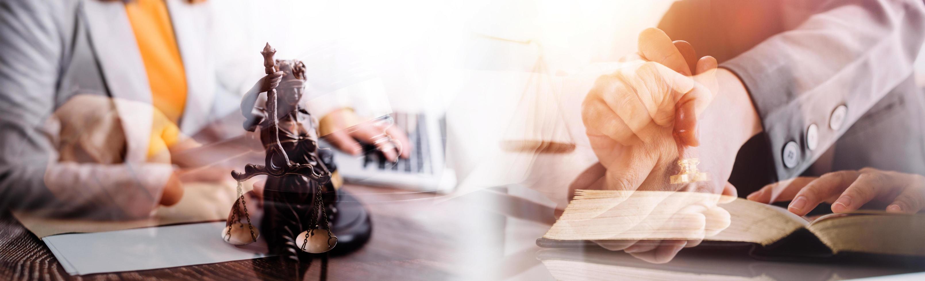 Justice and law concept.Male judge in a courtroom with the gavel, working with, computer and docking keyboard, eyeglasses, on table in morning light photo