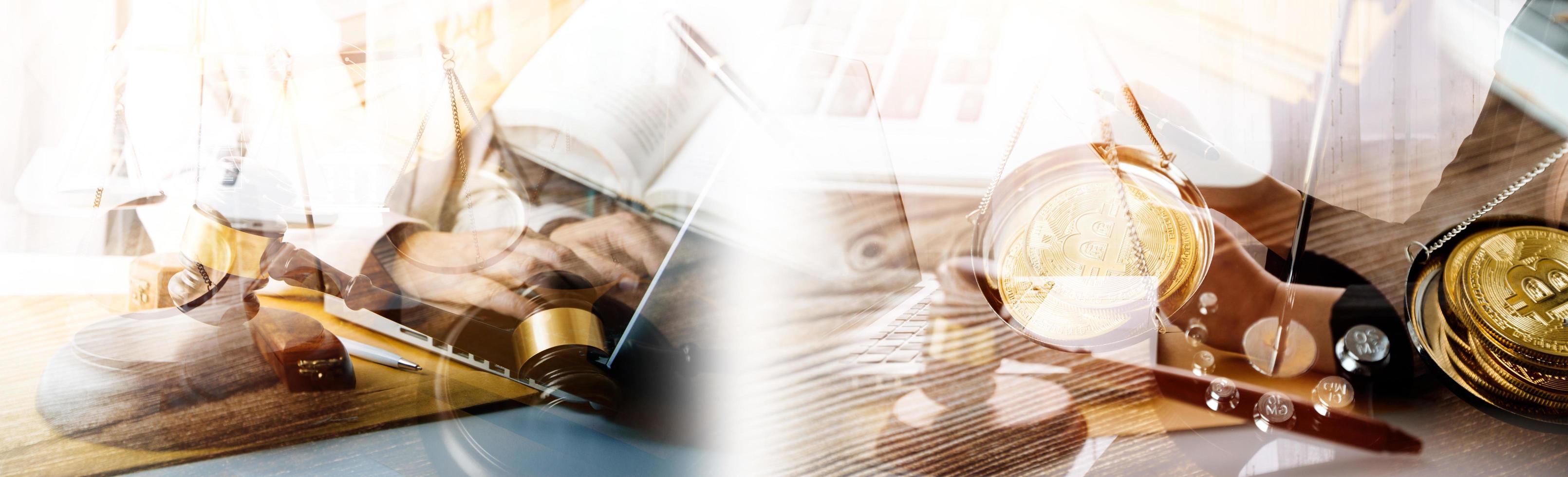 Justice and law concept.Male judge in a courtroom with the gavel, working with, computer and docking keyboard, eyeglasses, on table in morning light photo