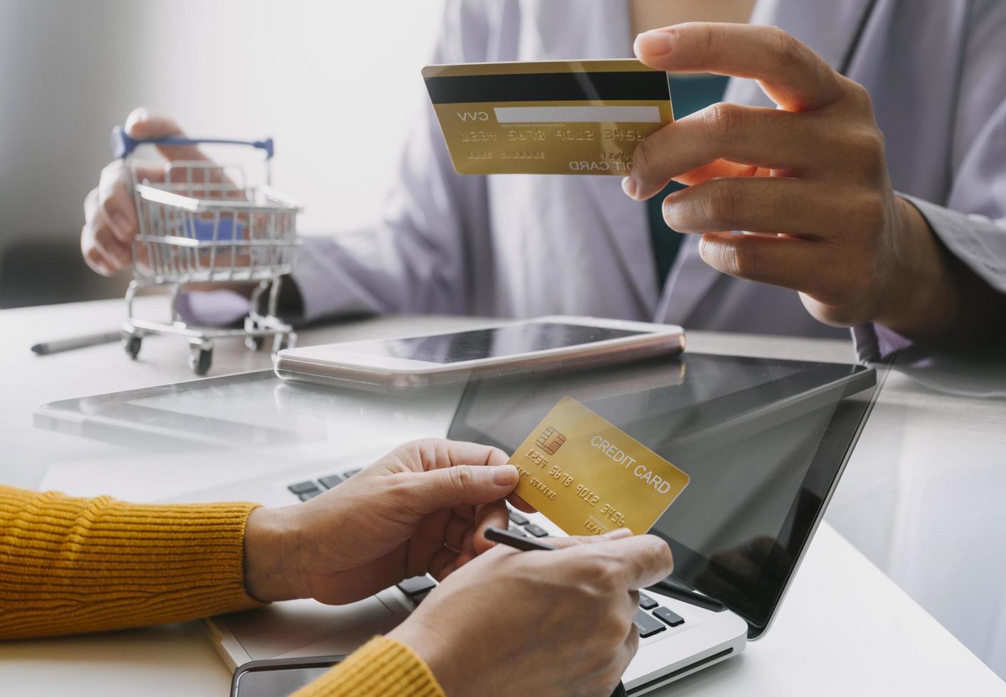 Hands holding credit card and using laptop. Online shopping photo