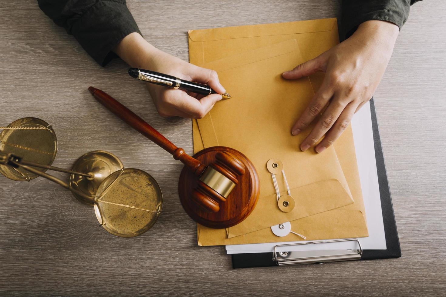 Male lawyer working with contract papers and wooden gavel on tabel in courtroom. justice and law ,attorney, court judge, concept. photo