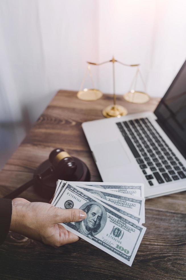 Business and lawyers discussing contract papers with brass scale on desk in office. Law, legal services, advice, justice and law concept picture with film grain effect photo