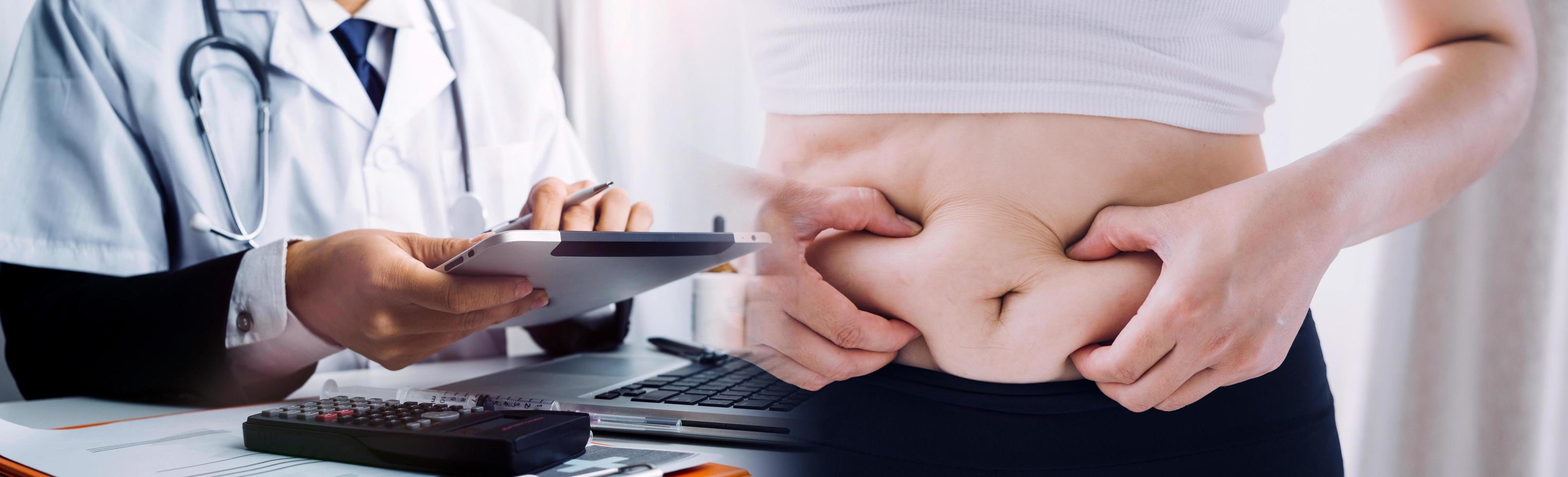 Fat woman hand holding excessive belly fat with measuring tape on white background. Shape up healthy stomach muscle and diet lifestyle to reduce belly concept. photo