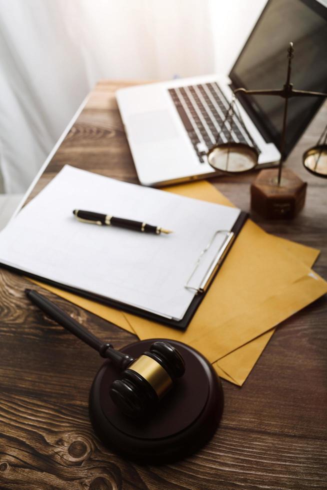 Business and lawyers discussing contract papers with brass scale on desk in office. Law, legal services, advice, justice and law concept picture with film grain effect photo