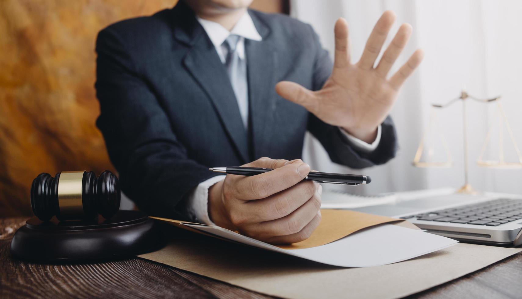 Business and lawyers discussing contract papers with brass scale on desk in office. Law, legal services, advice, justice and law concept picture with film grain effect photo