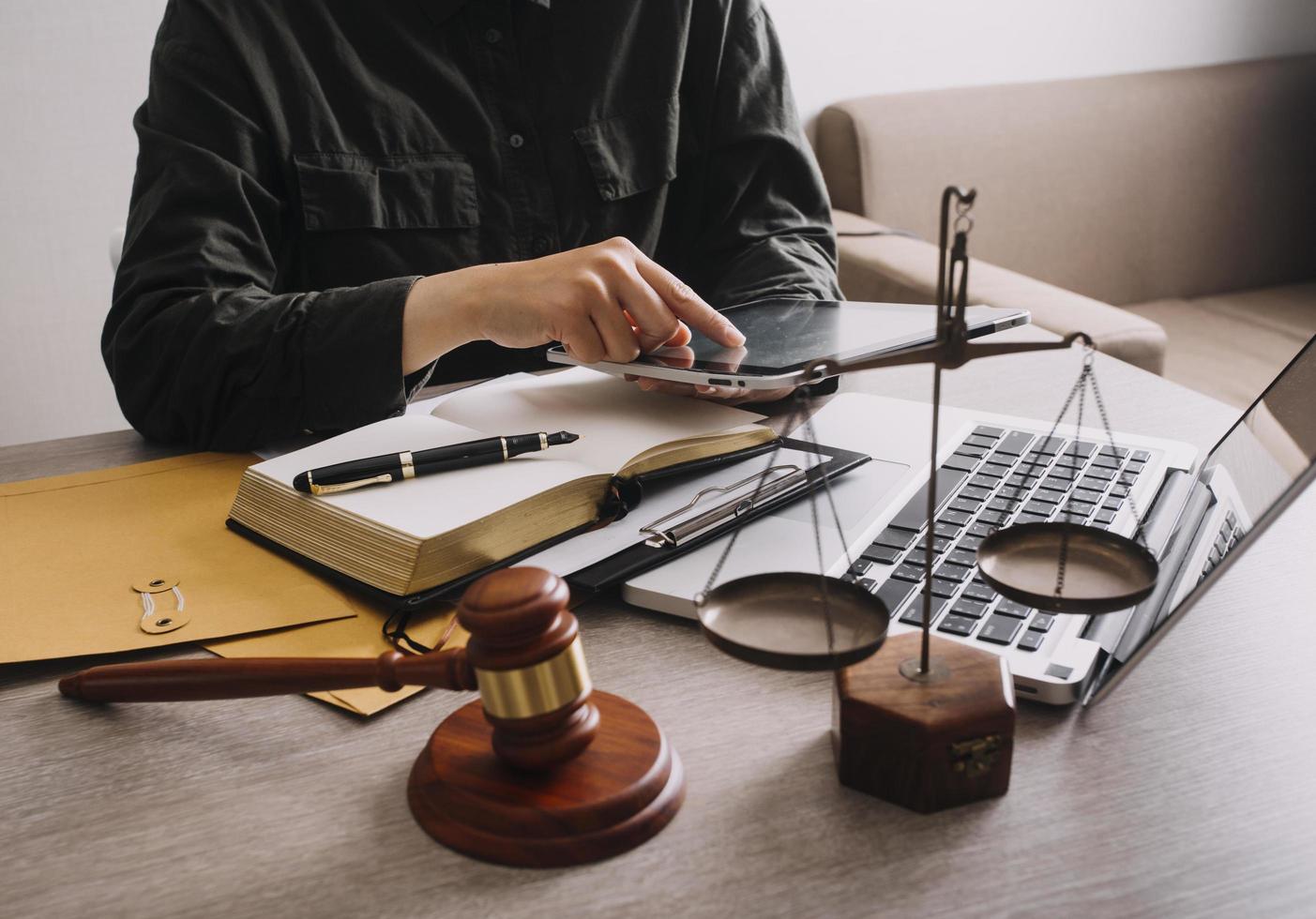 Male lawyer working with contract papers and wooden gavel on tabel in courtroom. justice and law ,attorney, court judge, concept. photo