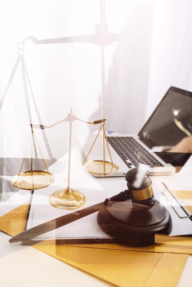 Business and lawyers discussing contract papers with brass scale on desk in office. Law, legal services, advice, justice and law concept picture with film grain effect photo