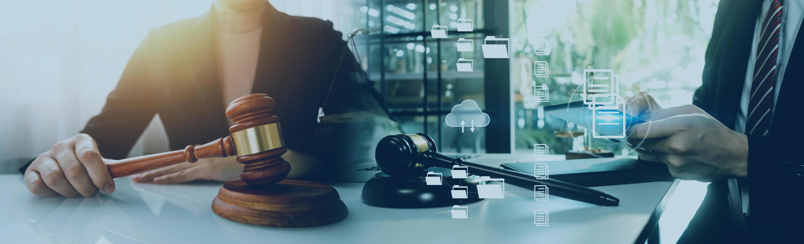 Justice and law concept.Male judge in a courtroom with the gavel, working with, computer and docking keyboard, eyeglasses, on table in morning light photo