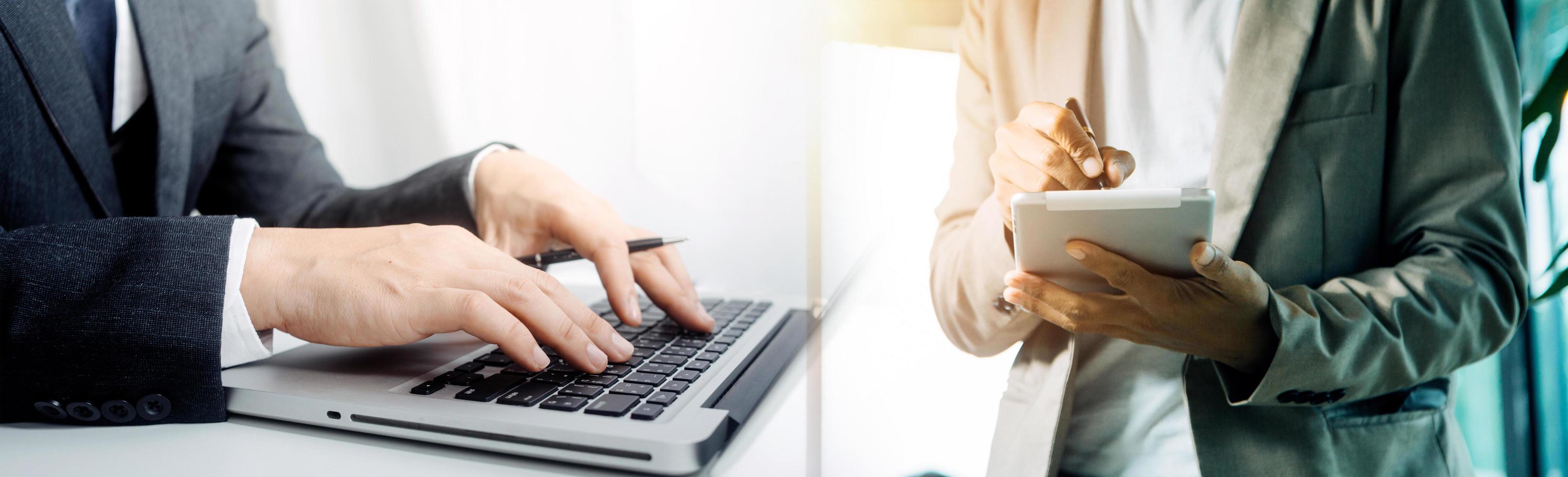 businesswoman hand working with laptop computer, tablet and smart phone in modern office with virtual icon diagram at modernoffice in morning light photo