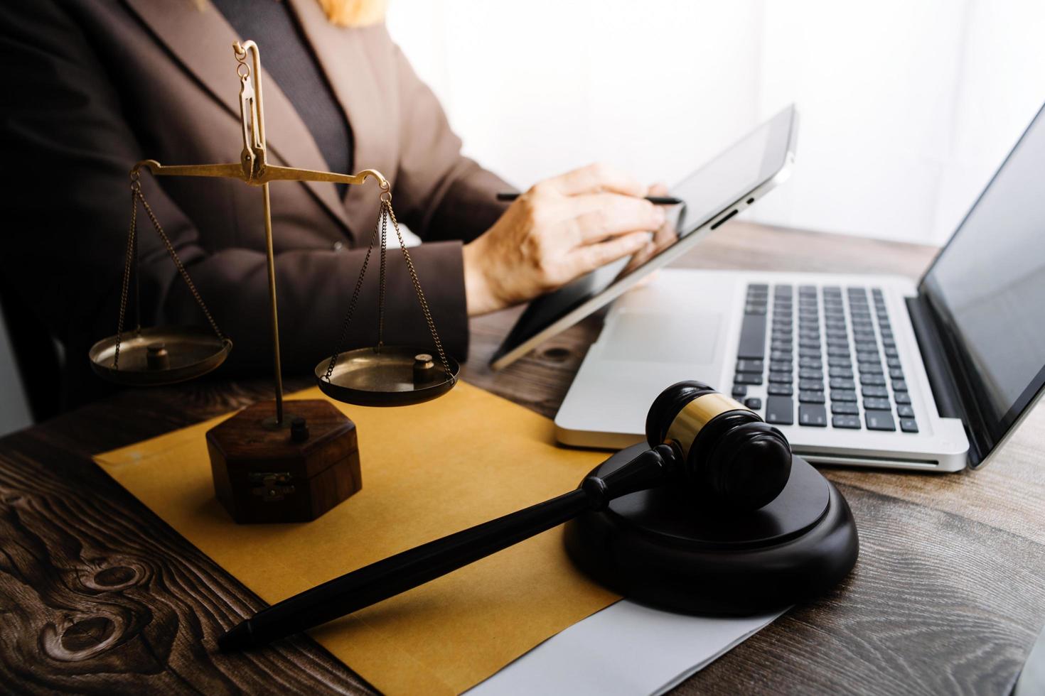 justice and law concept.Male judge in a courtroom on wooden table and Counselor or Male lawyer working in office. Legal law, advice and justice concept. photo