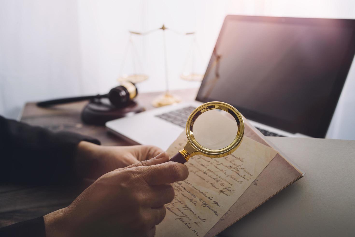 Business and lawyers discussing contract papers with brass scale on desk in office. Law, legal services, advice, justice and law concept picture with film grain effect photo