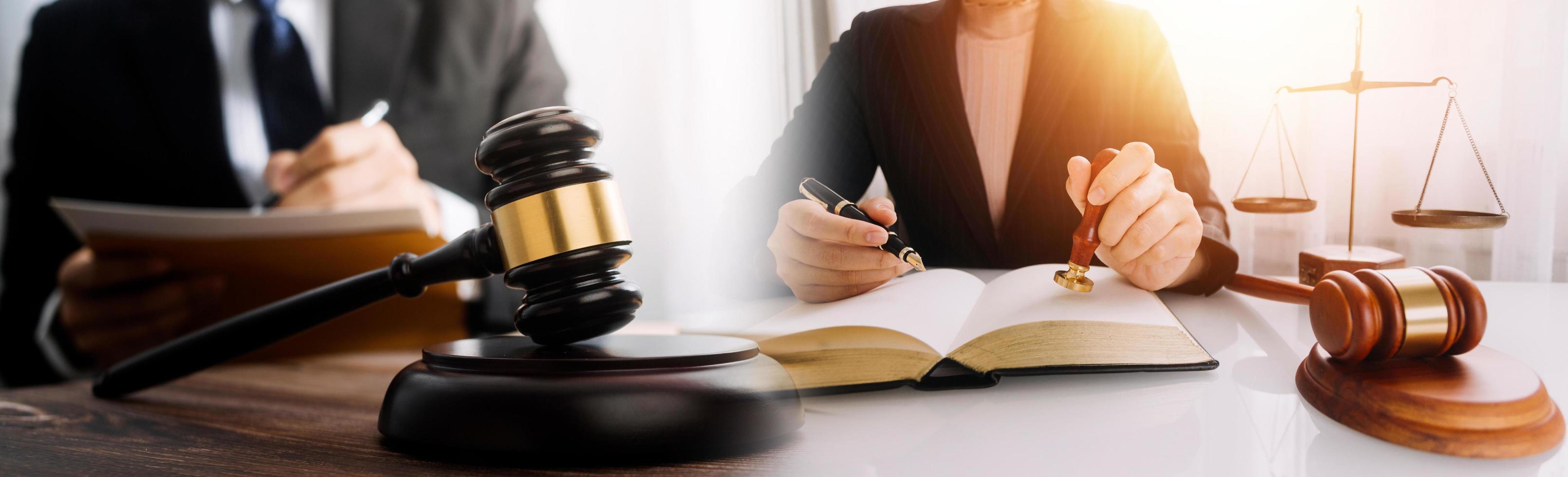 Justice and law concept.Male judge in a courtroom with the gavel, working with, computer and docking keyboard, eyeglasses, on table in morning light photo