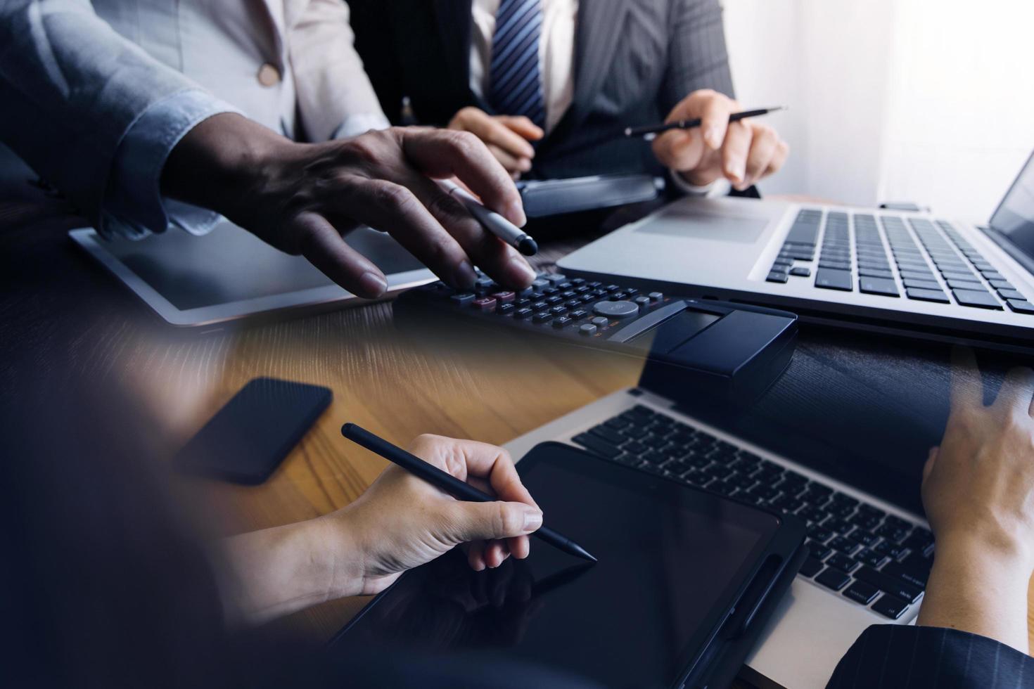 Businessman and team analyzing financial statement Finance task. with smart phone and laptop and tablet. Wealth management concept photo