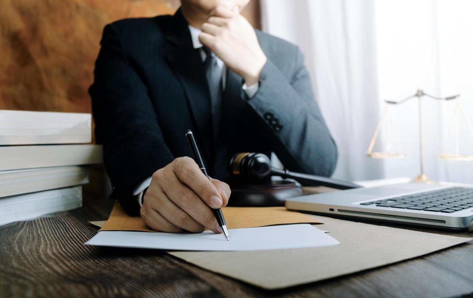 Business and lawyers discussing contract papers with brass scale on desk in office. Law, legal services, advice, justice and law concept picture with film grain effect photo