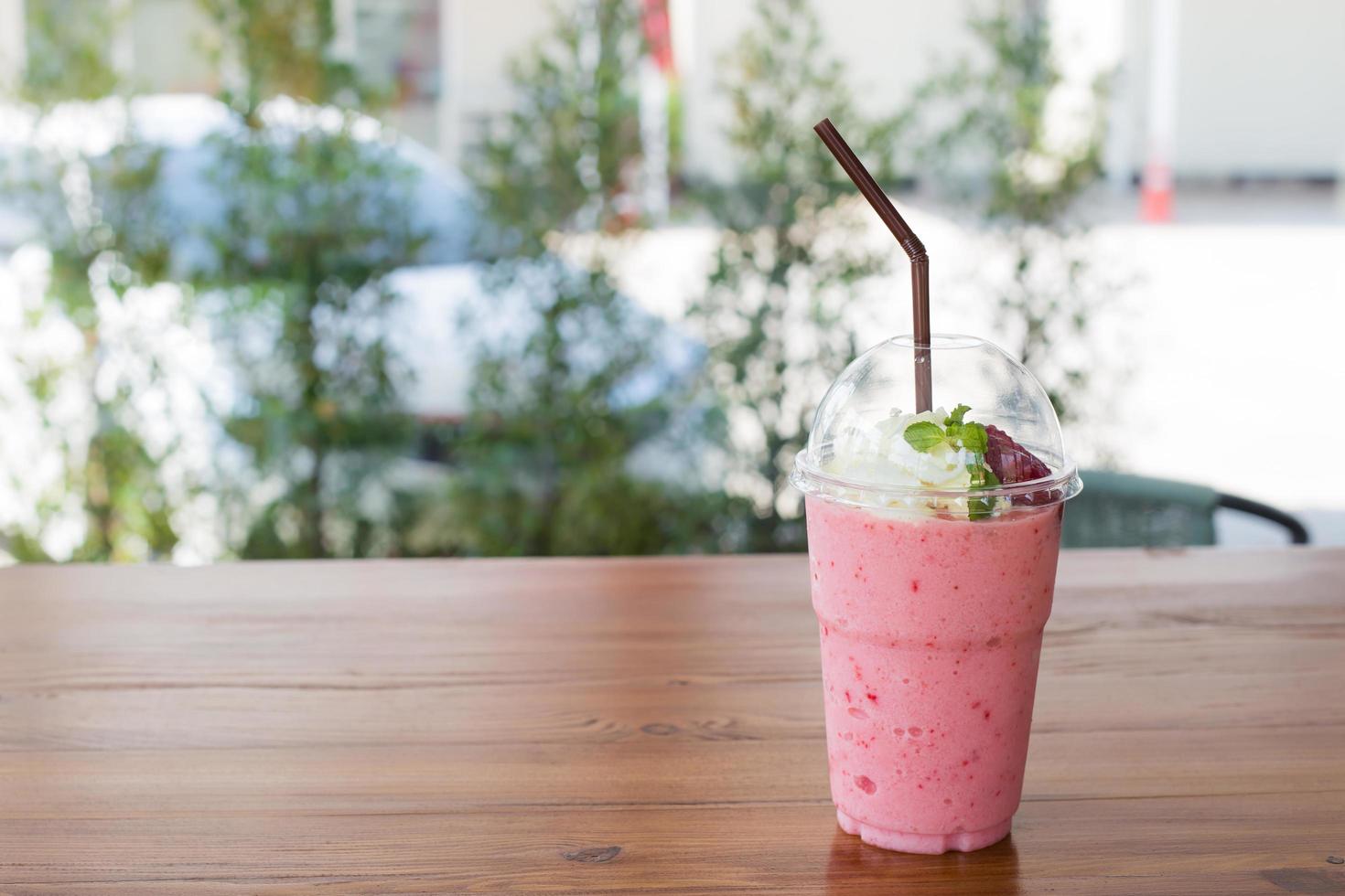 Strawberry smoothies summer strawberry with leaf of mint on wooden table. Fresh fruits photo