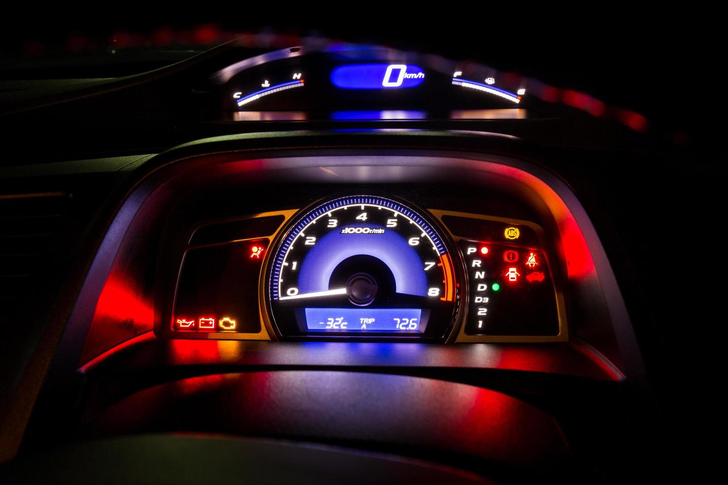 Modern car instrument dashboard panel and digital speed meter in night time photo
