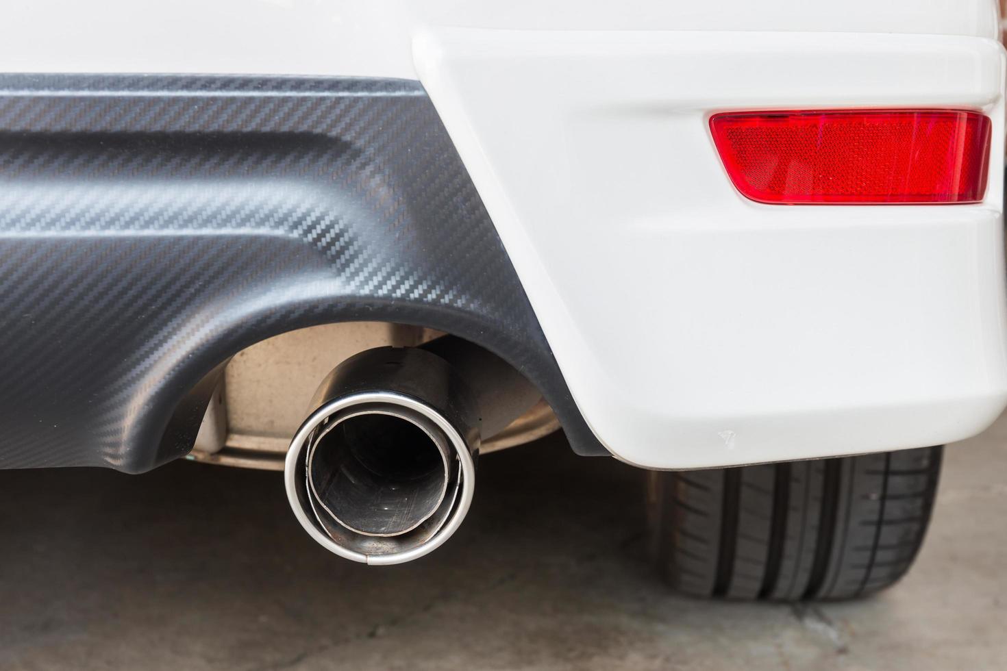 Chrome pipe of white powerful sport car bumper photo