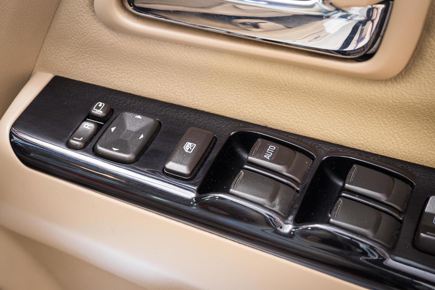 Close Up of controls button switch on the door. Interior detail in luxury modern car photo