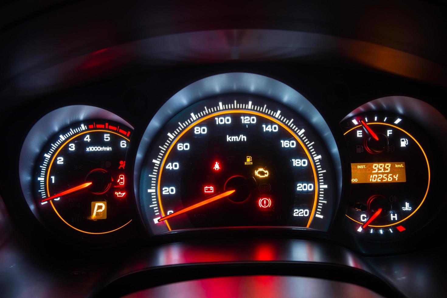 Modern car instrument dashboard panel in night time photo