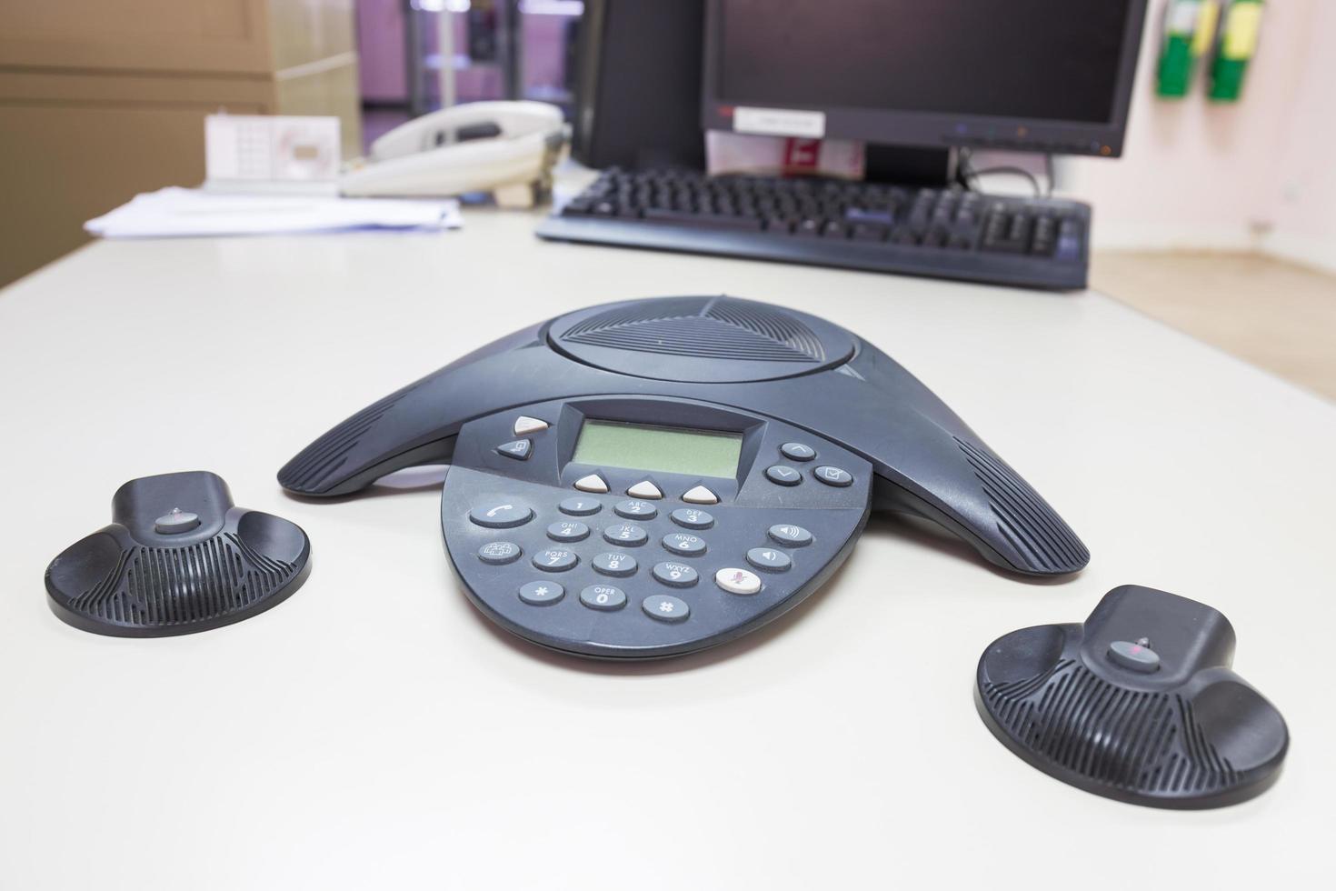 Conference IP phone on white table background photo