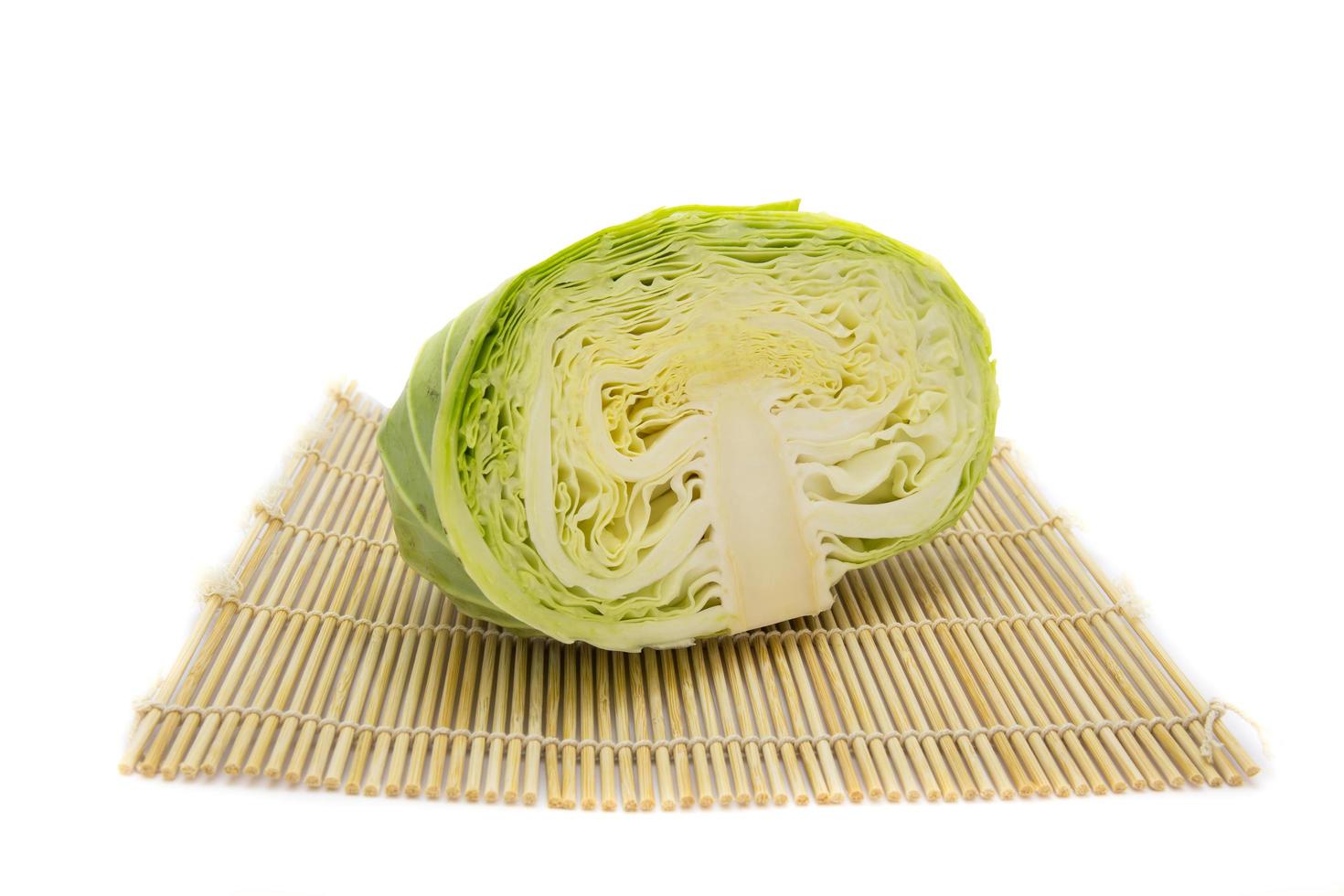 closeup cutted cabbage on traditional mat isolated white background photo