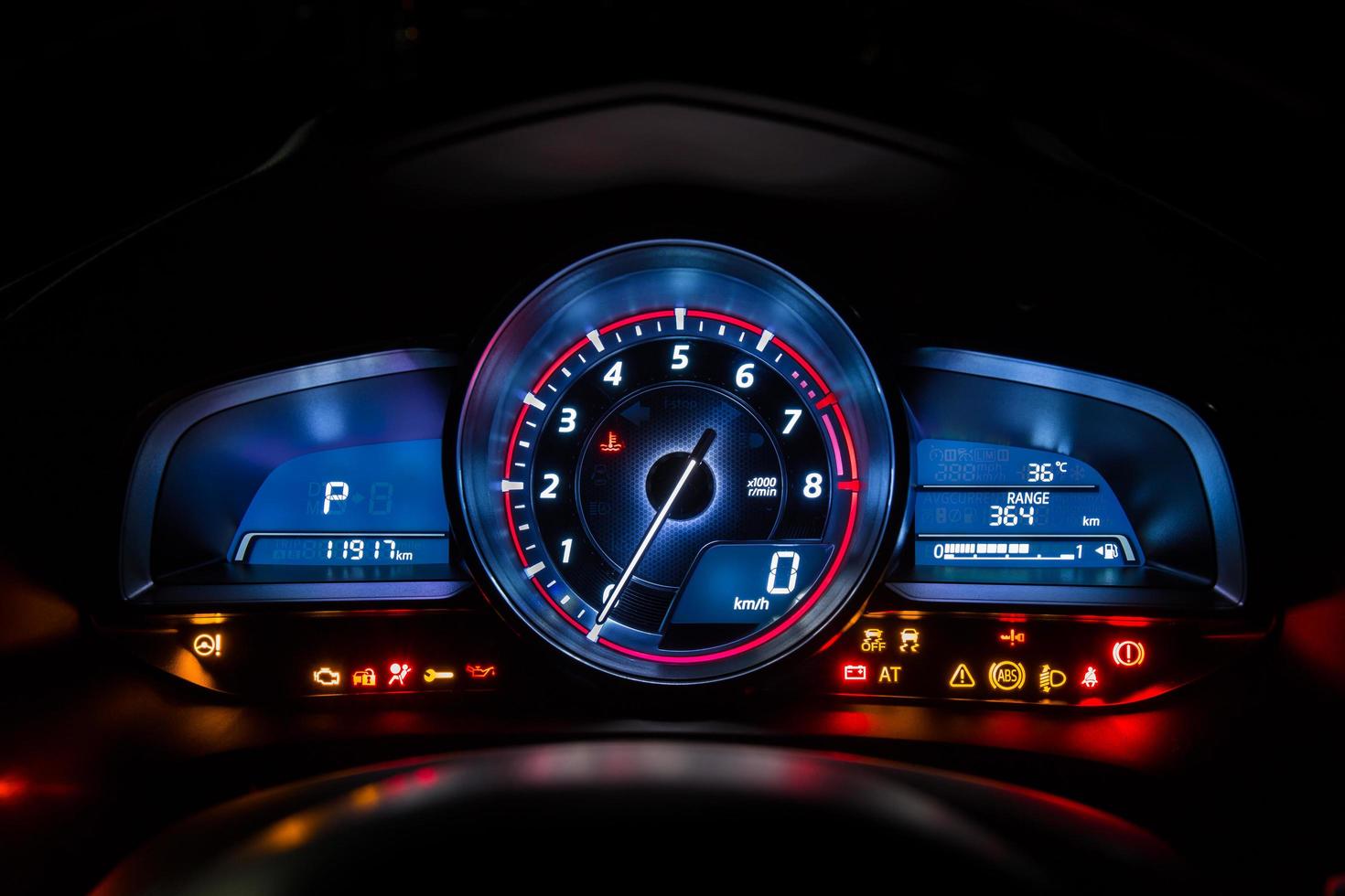 Modern car instrument dashboard panel or speedometer and full symbol in night time photo