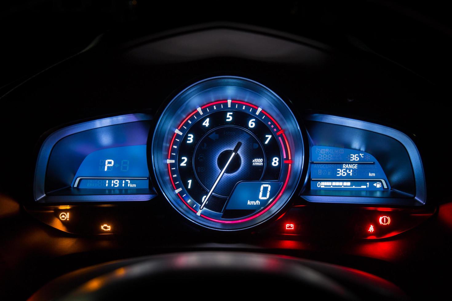Modern car instrument dashboard panel or speedometer in night time photo