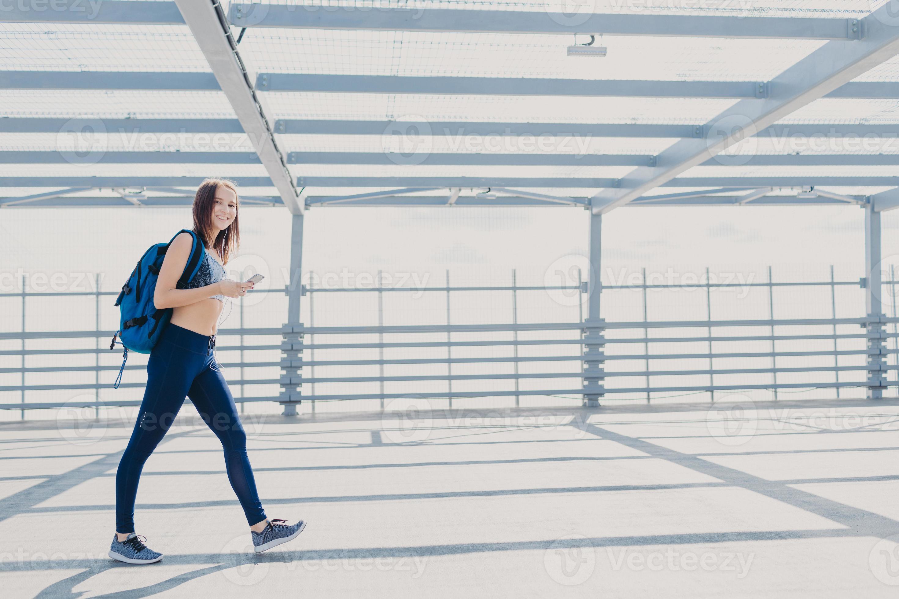 Active female fitness trainer dressed in sportsclothes, sneakers
