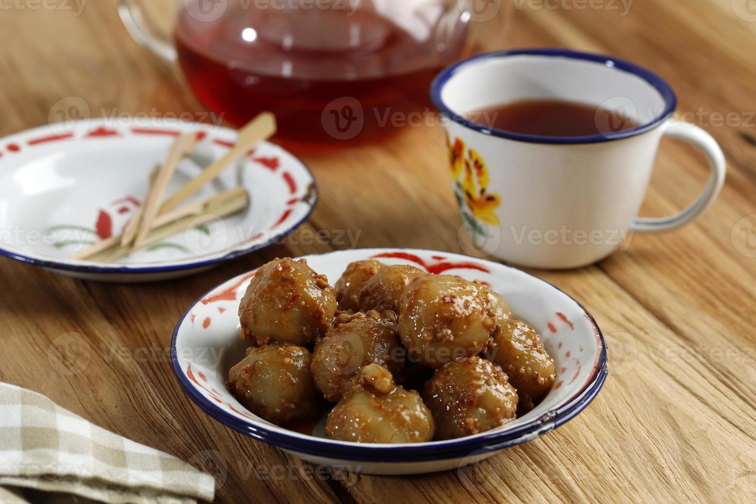 Cilok is Aci Dicolok, Traditional Street Food from West Java, Made from Tapioca or Aci Flour. Cilok is a Round Shaped Snack with a Chewy Texture, Served with Peanut Sauce photo