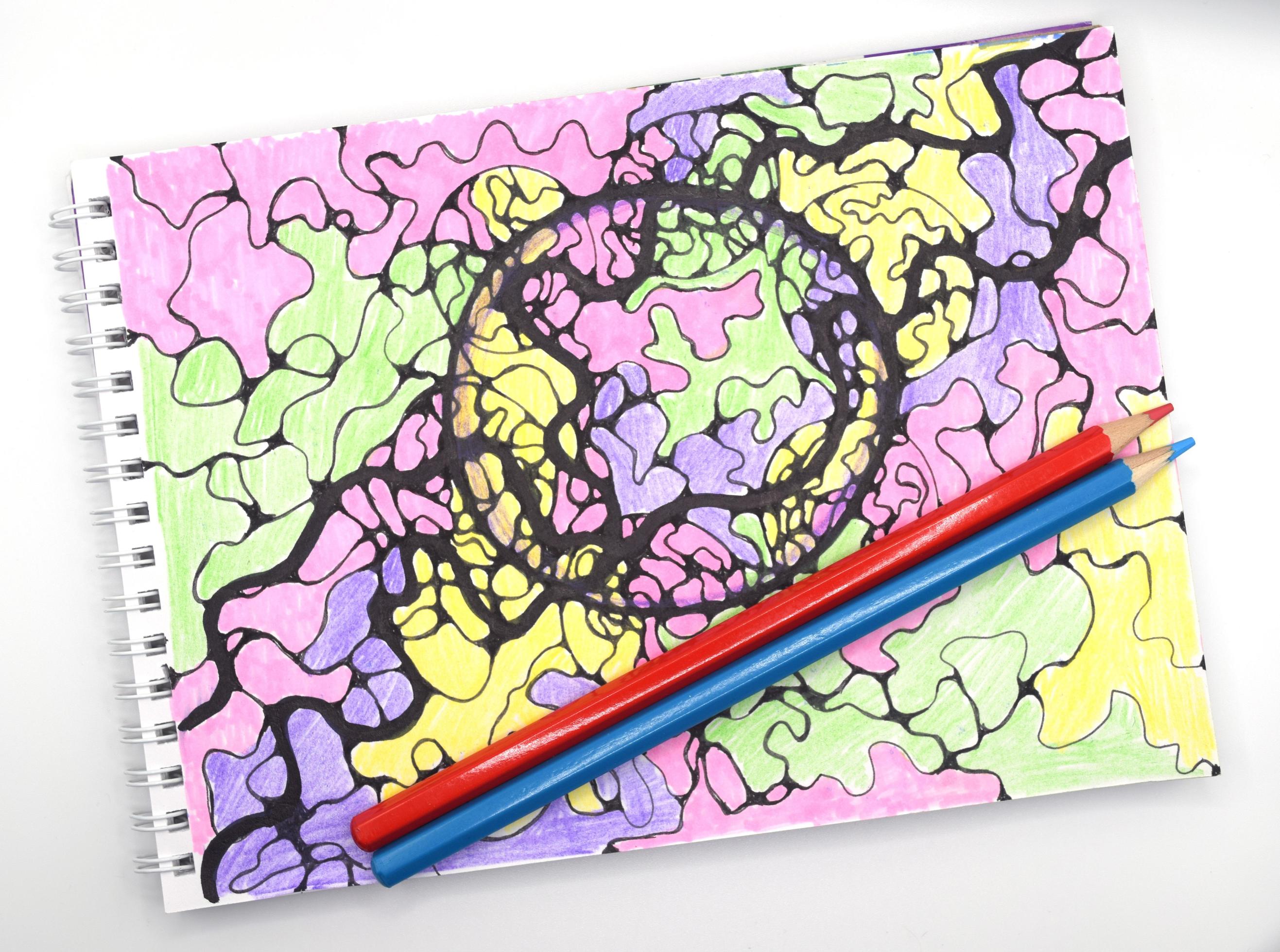 notepad, sketchbook, colored pencils and drawing of neural connections
