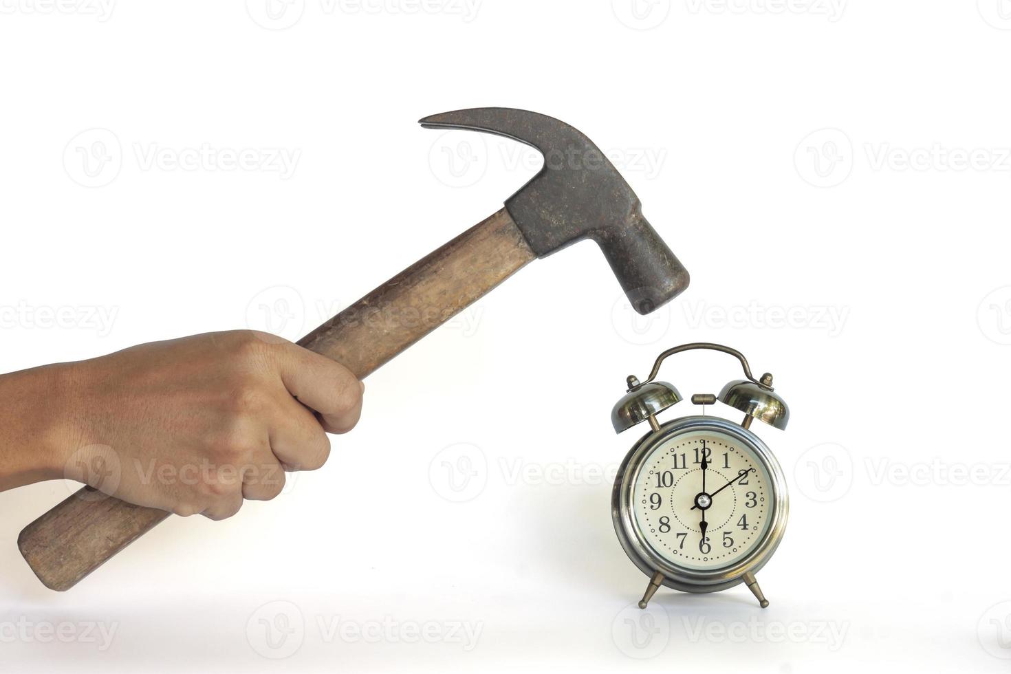 Hand of men holding a hammer to smash the alarm clock isolated on white background included clipping path. photo