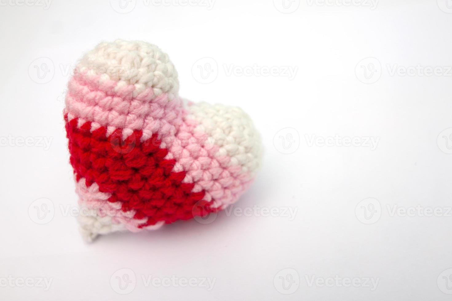 Crochet varicolored heart shape made from yarn isolated on white background for Valentine's day. photo
