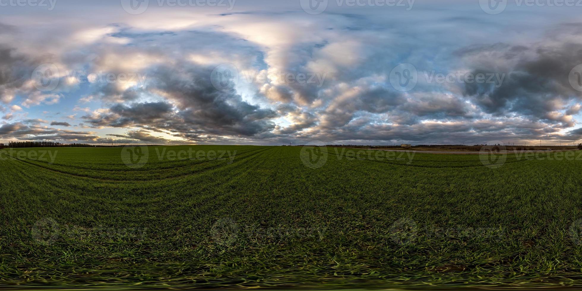 full seamless spherical hdri panorama 360 degrees angle view among fields in evening sunset with awesome blue pink red clouds in equirectangular projection, ready for VR AR virtual reality photo