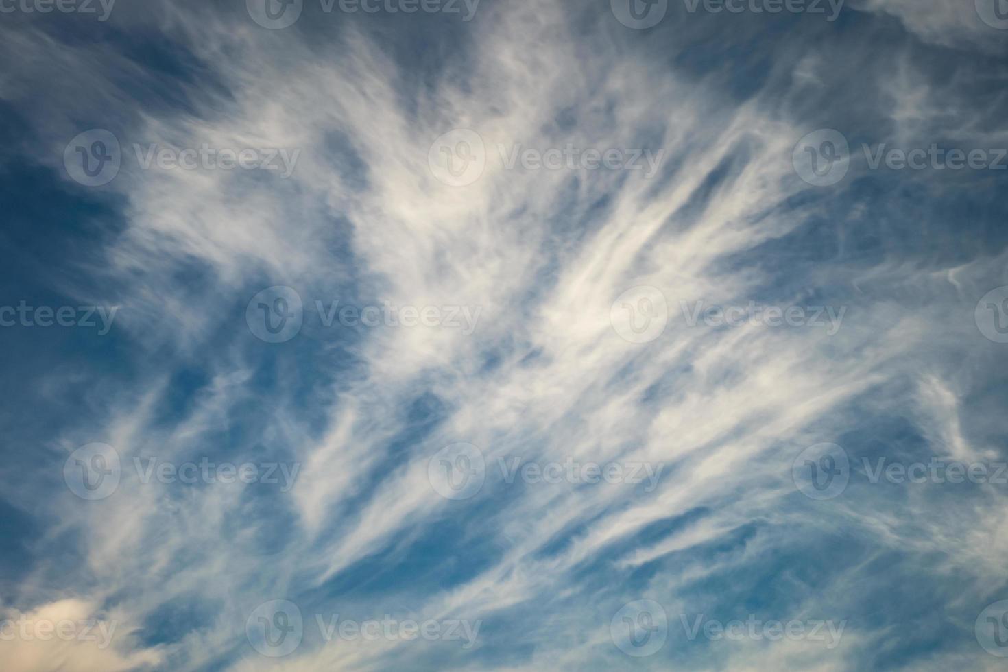 Blue sky background with tiny stratus cirrus striped clouds. Clearing day and Good windy weather photo