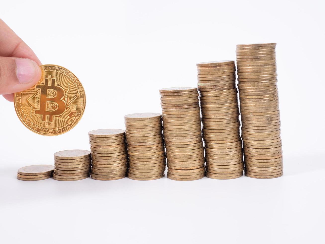 Man's hand put money coins to stack of  cryptocurrency. Money, Financial, Business Growth concept photo
