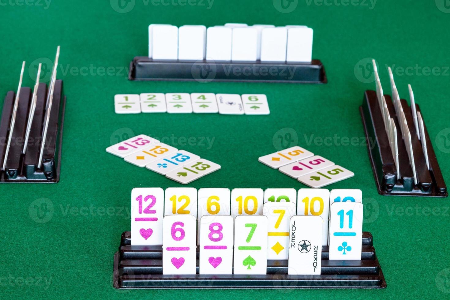 tiles in rack and gameplay in Rummy on table photo