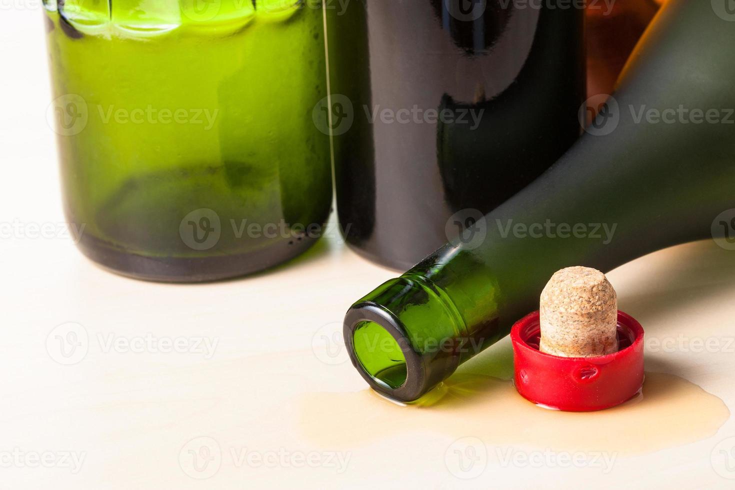 brandy bottle and cork closeup near empty bottles photo