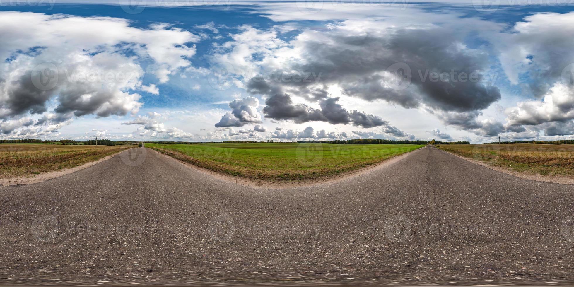 full seamless spherical hdri panorama 360 degrees angle view on old asphalt road among fields in autumn day with awesome clouds in equirectangular projection, ready for VR AR virtual reality content photo