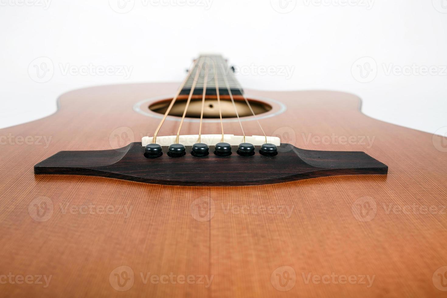 wood texture of lower deck of six strings acoustic guitar on white background. guitar shape photo