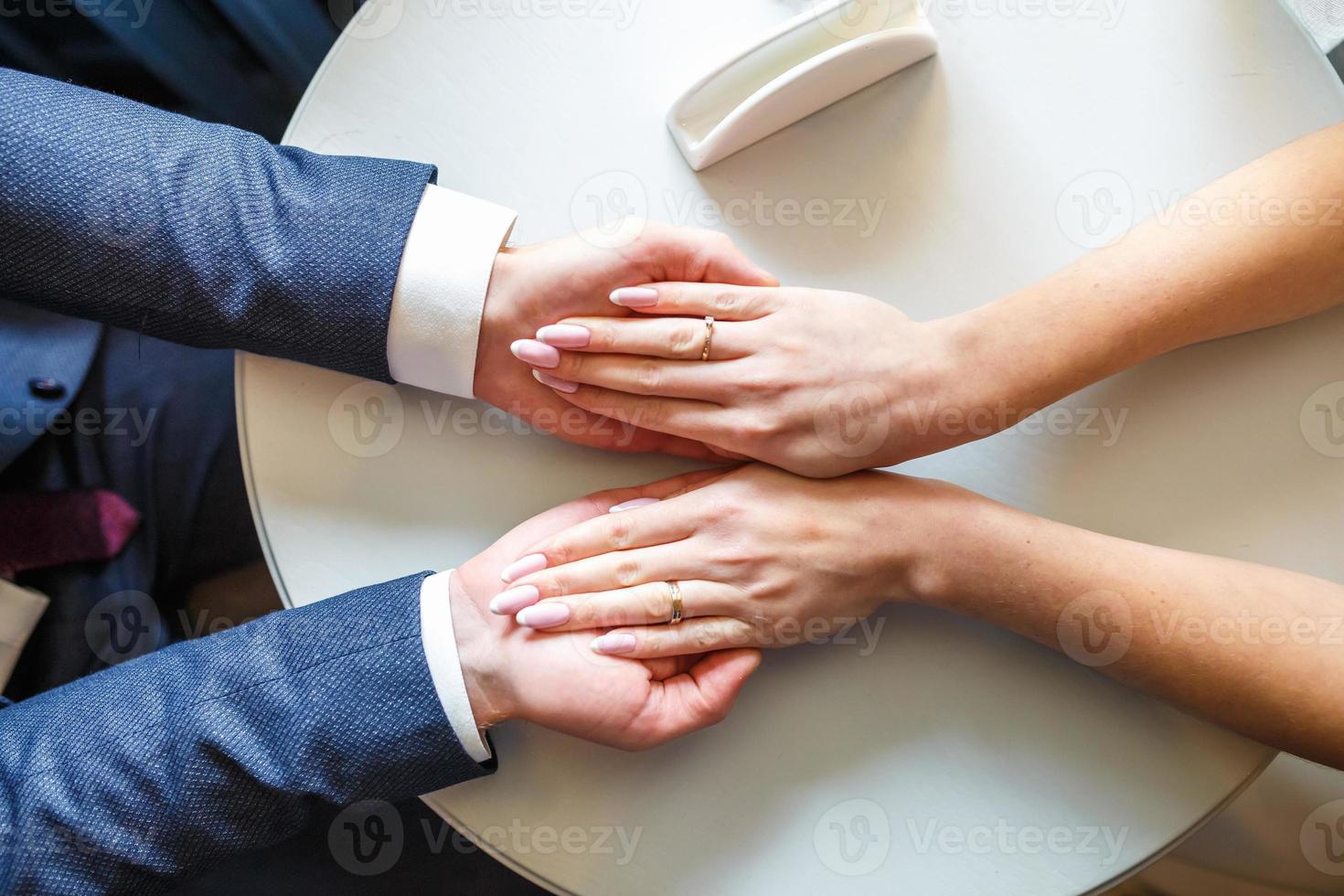 romantic couple holding hands. Lovers or newlywed married young couple in romance. wedding theme. top view photo