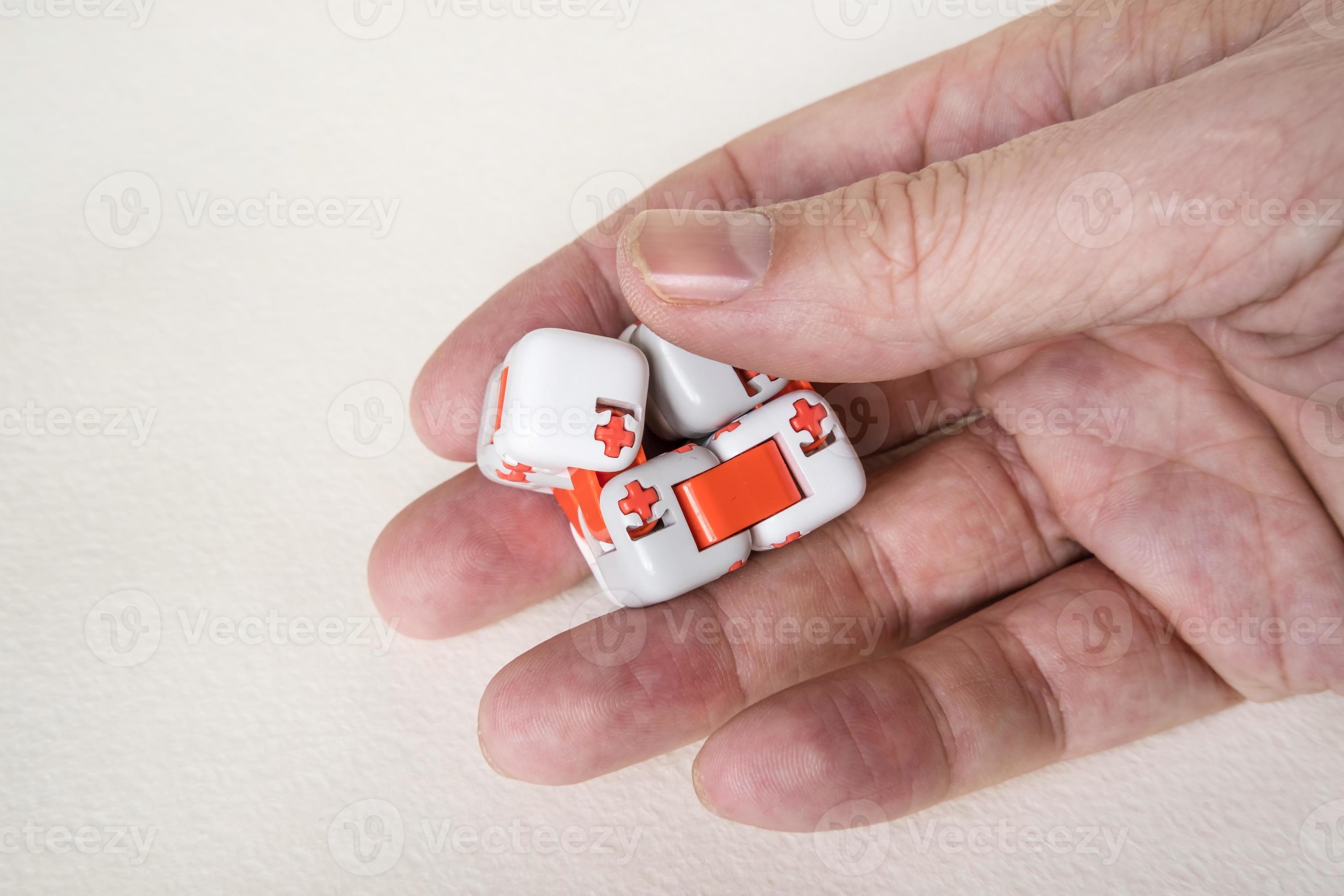 Colorful fingers antistress fidget cube toy in hand on white background.  development of fine motor skills of fingers of children 10336547 Stock  Photo at Vecteezy