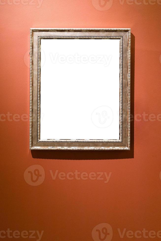 verical silver picture frame on red brown wall photo