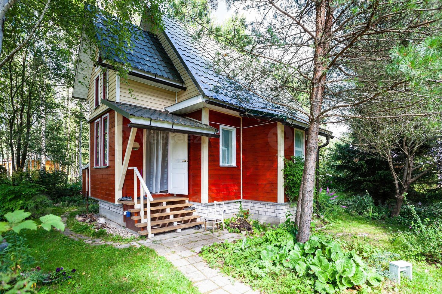 one-storey wooden country house with attic photo