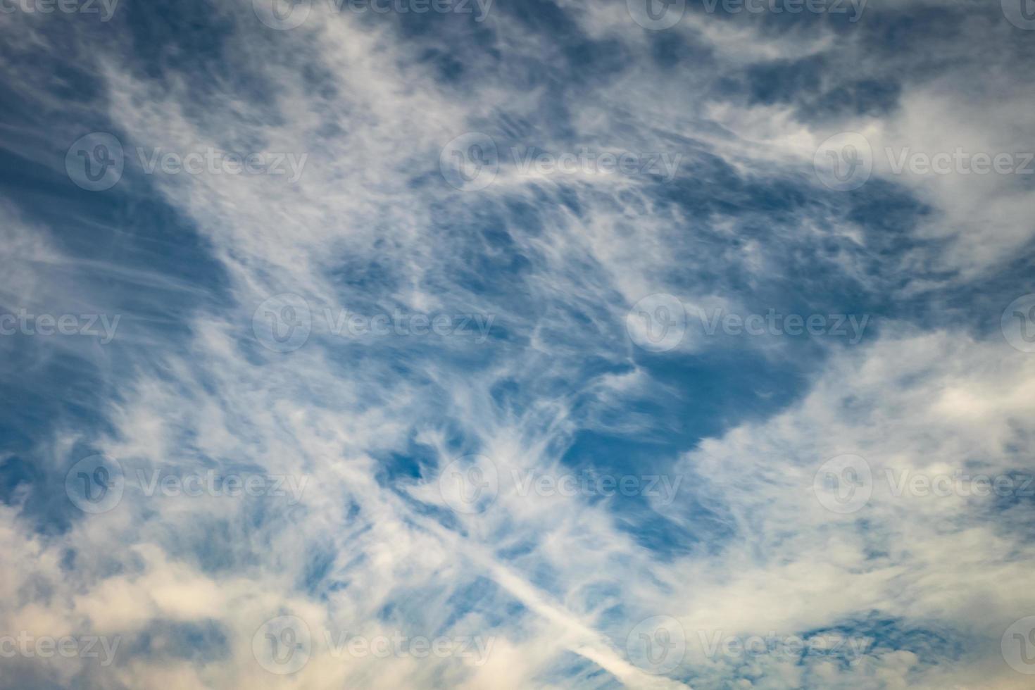 Blue sky background with tiny stratus cirrus striped clouds. Clearing day and Good windy weather photo