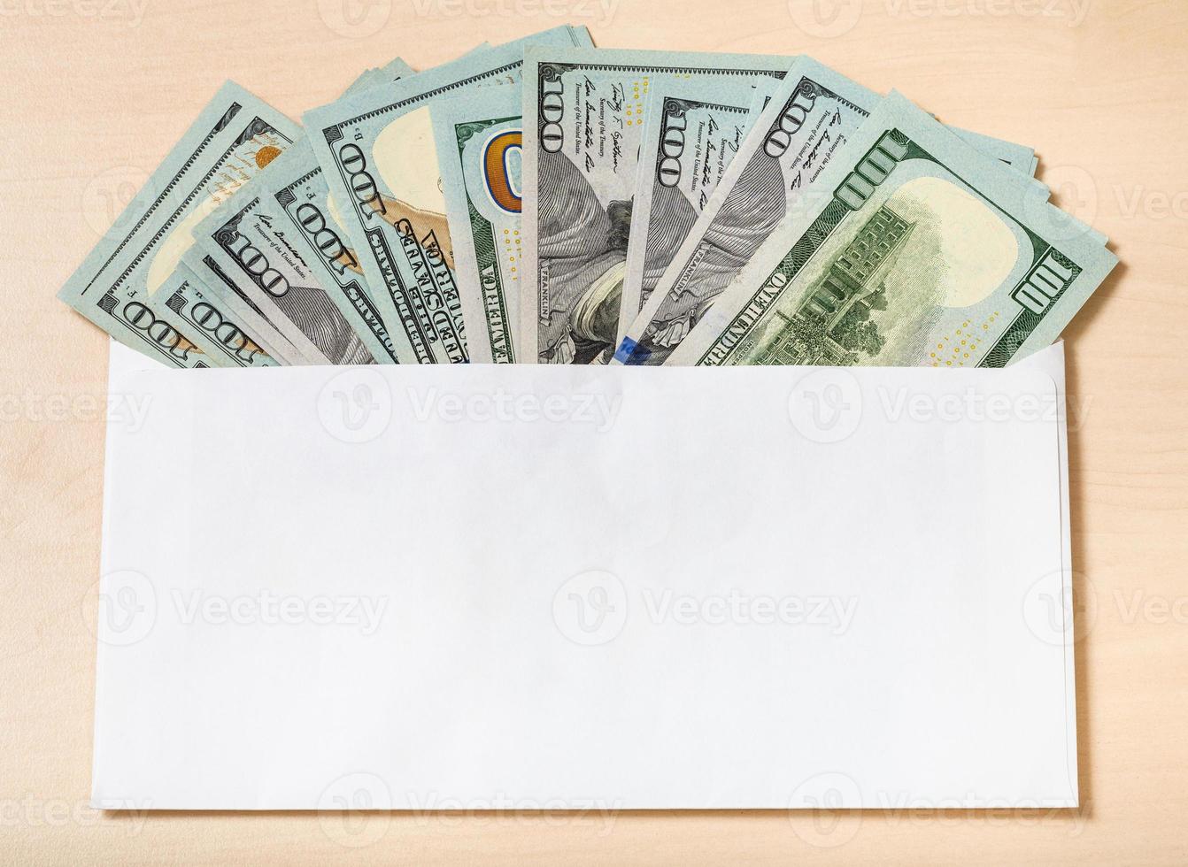 fan from one hundred dollars bills in envelope photo